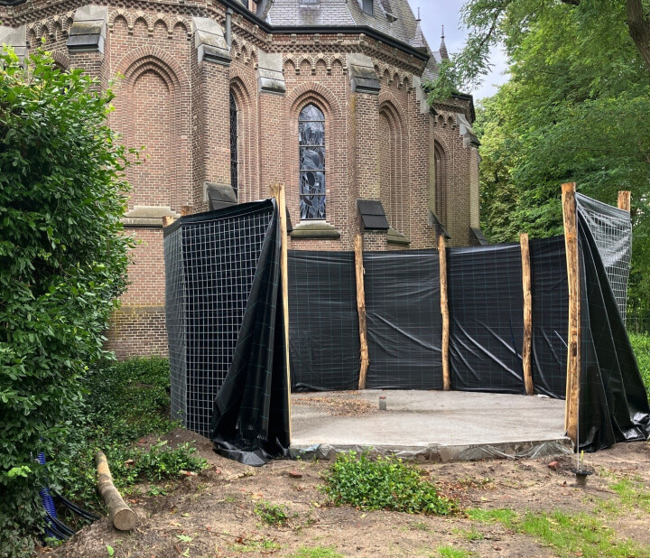 De biomeiler bouwden we in de tuin achter de abdijkerk. Nu deze klaar is, halen we er warmte mee uit compost.